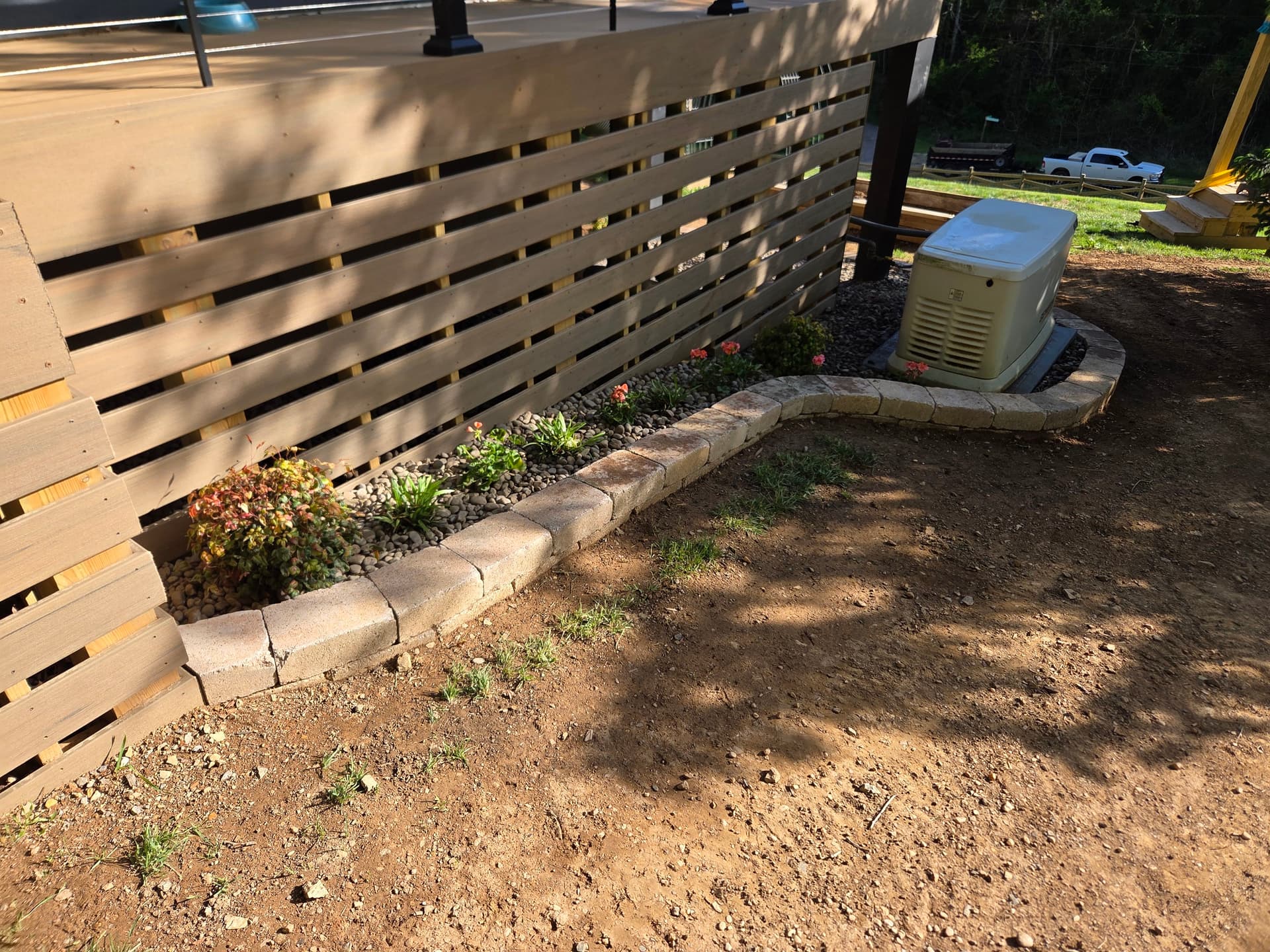 Clean Landscape Border and Decorative Stone Bed Under a Deck image